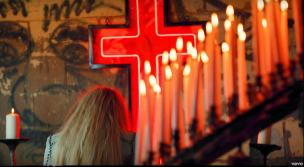 Kesha sits at an altar in 'Praying'