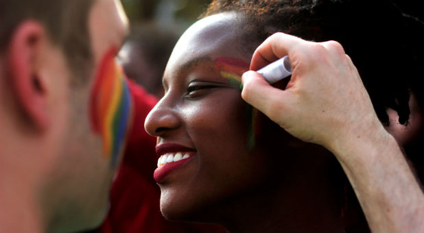 Participants get ready as they attend a gay pride parade promoting lesbian, gay, bisexual and transgender rights.