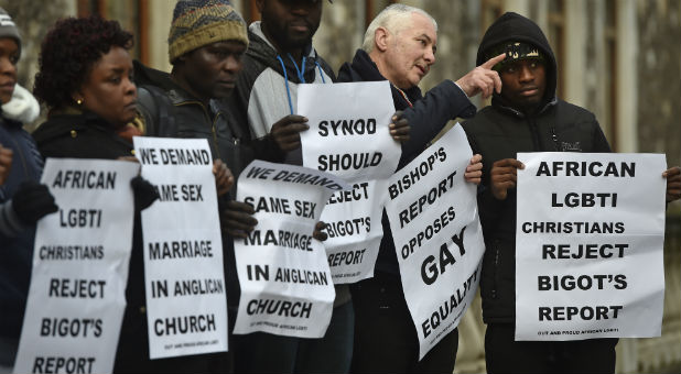 People participate in a vigil against Anglican homophobia, outside the General Synod of the Church of England in London, Britain.