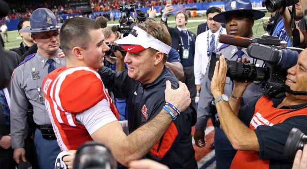 New Orleans, LA, USA; Mississippi Rebels quarterback Chad Kelly (10) hugs head coach Hugh Freeze at the end of the 2016 Sugar Bowl against the Oklahoma State Cowboys at the Mercedes-Benz Superdome. Mississippi won, 48-20.