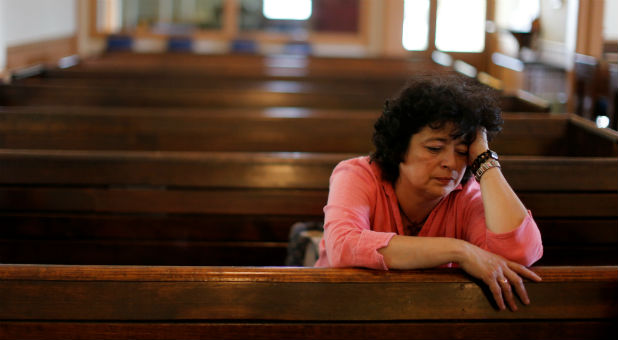 Immigrant Rosa Sabido sits in the United Methodist Church in which she lives while facing deportation in Mancos, Colorado.