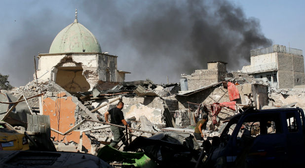 Members of Iraqi Counter Terrorism Service sift through the ruins of the Grand al-Nuri Mosque at the Old City in Mosul, Iraq, June 29, 2017.