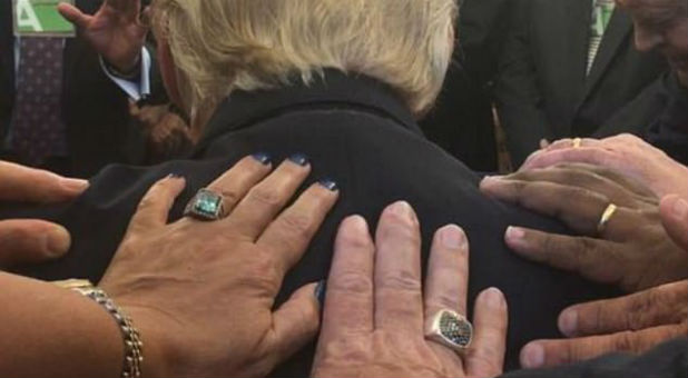 Members of the Faith Advisory Council lay hands on President Trump.