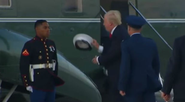 President Trump returns a Marine's hat.