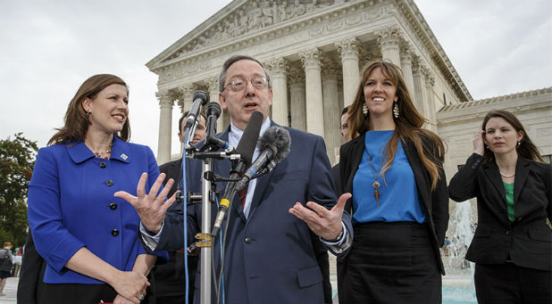 Attorney Douglas Laycock, center, characterizes his argument before the Supreme Court on behalf of an Arkansas prison inmate who says his Muslim beliefs that require him to grow a beard are being violated by prison rules that prevent beards on Oct. 7, 2014, in front of the court in Washington. Laycock, a professor at the University of Virginia School of Law, is working with the Beckett Fund for Religious Liberty which prevailed in the Hobby Lobby case last June. At left is Hannah Smith, a senior counsel with the Becket Fund. At right is Emily Hardman and Diana Verm, far right, both of the Beckett Fund.