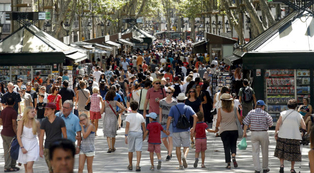 People walk by Las Ramblas in Barcelona, Spain, Aug. 16, 2015.
