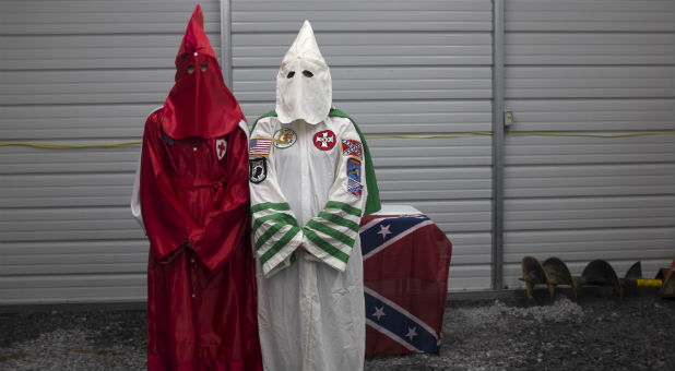Female members of the Virgil Griffin White Knights, which claims affiliation with the Ku Klux Klan, pose for a photograph in their robes ahead of a cross lighting ceremony at a private farmhouse in Carter County, Tennessee, July 4, 2015.