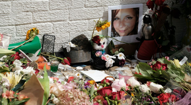 Flowers and a photo of car ramming victim Heather Heyer lie at a makeshift memorial in Charlottesville, Virginia.