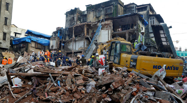 Firefighters and rescue workers search for survivors at the site of a collapsed building in Mumbai, India.