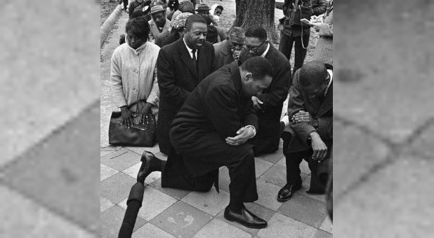 Martin Luther King Jr. takes a knee.