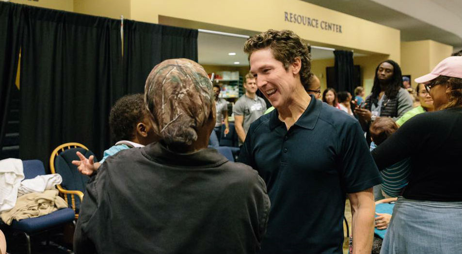 Joel Osteen speaks with refugees at Lakewood Church.