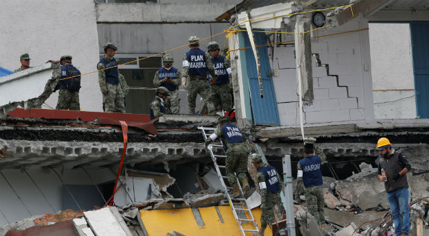 Soldiers search in the rubble of a collapsed building after an earthquake in Mexico City, Mexico.