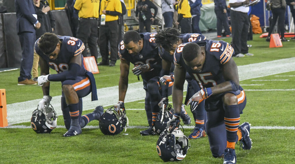 Athletes kneel to protest racial injustice.