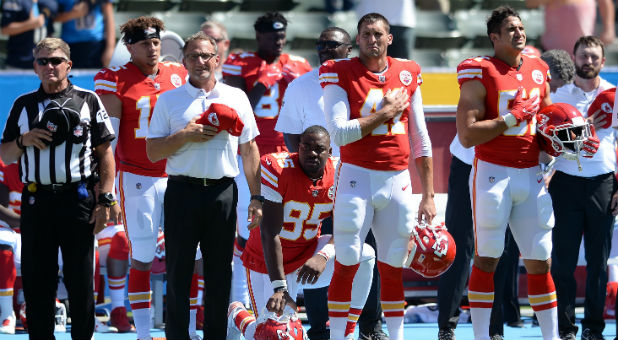 Kansas City Chiefs defensive end Chris Jones (95) kneels in protest during the national anthem.