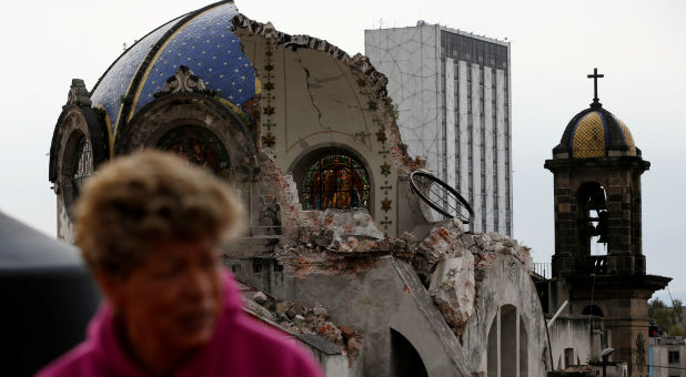 A person walks past the church dome of Our lady of los Angeles, which collapsed six days after an earthquake, in Mexico City, Mexico.