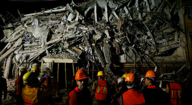 Rescuers work at the site of a collapsed building after an earthquake in Mexico City, Mexico.