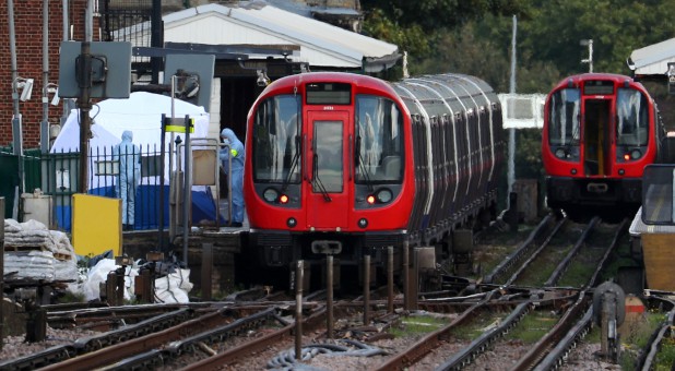 Forensic investigators search on the platform at Parsons Green tube station in London, Britain.