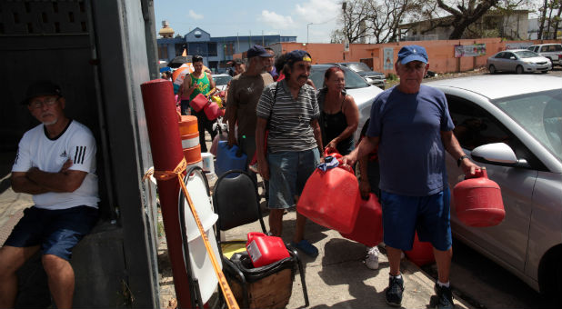 People queue at a gas station to fill up their fuel containers after the island was hit by Hurricane Maria, in San Juan, Puerto Rico.