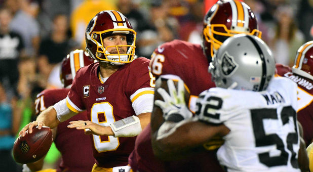 Washington Redskins quarterback Kirk Cousins (8) drops back to pass against the Oakland Raiders.