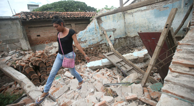 A person walks over debris after the Mexico earthquake.