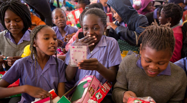 Girls open their Operation Christmas Child shoe boxes.