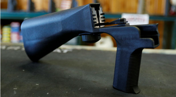 A bump fire stock attaches to a semi-automatic rifle to increase the firing rate.