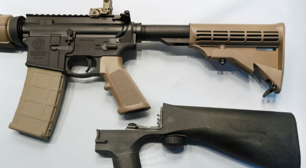 A bump fire stock that attaches to an semi-automatic assault rifle to increase its firing rate.