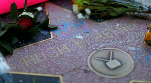 The star of late publisher Hugh Hefner is adorned with flowers and other items on the Hollywood Walk of Fame.