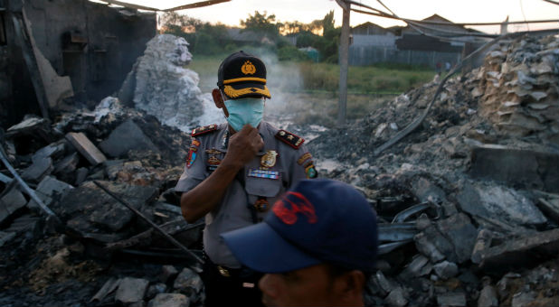 Policemen stand at the site of an explosion at a fireworks factory at Kosambi village in Tangerang, Indonesia.