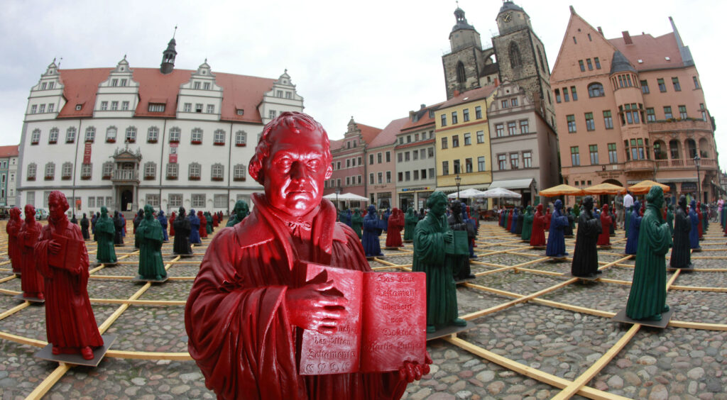 An art exhibit features plastic statues of Martin Luther.