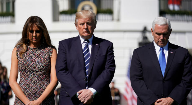 The first lady, president and vice-president observe a moment of silence.