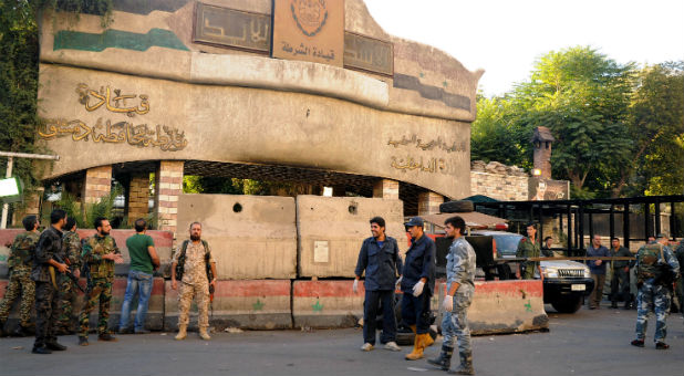 Syrian Army soldiers secure the area in front of police headquarters in central Damascus.
