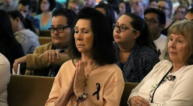 People pray during an interfaith memorial service in Las Vegas.
