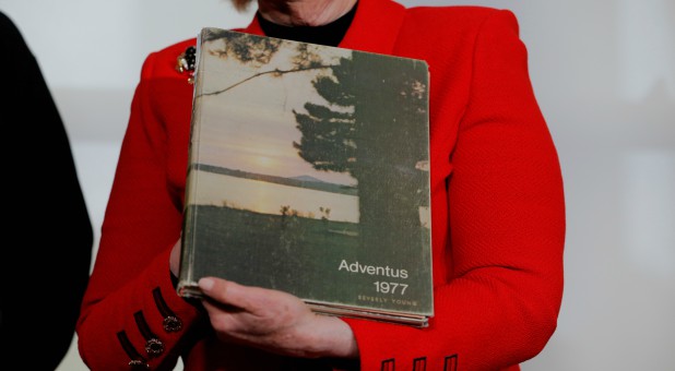 Attorney Gloria Allred holds a yearbook with the maiden name of accuser Beverly Young Nelson.