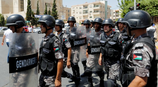 Jordanian police stand guard during a demonstration near the Israeli Embassy in Amman, Jordan.