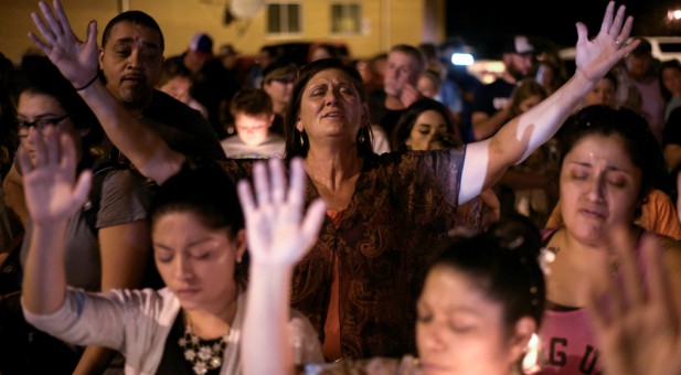 People worship at a candlelight vigil in Sutherland Springs, Texas.