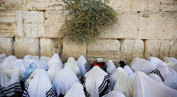 Jewish worshippers, covered in prayer shawls, take part in the priestly blessing during the Jewish holiday of Sukkot, at the Western Wall.