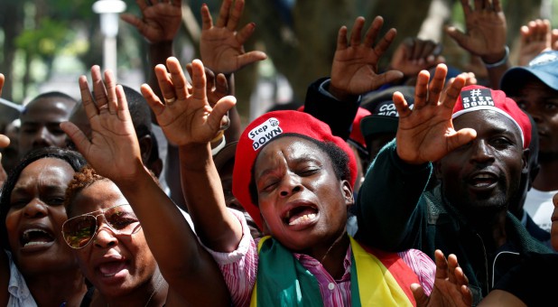 Protesters calling for Zimbabwean President Robert Mugabe to resign attend a prayer meeting outside parliament in Harare, Zimbabwe.