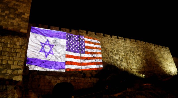 An Israeli national flag and an American one are projected on a part of the walls surrounding Jerusalem's Old City.