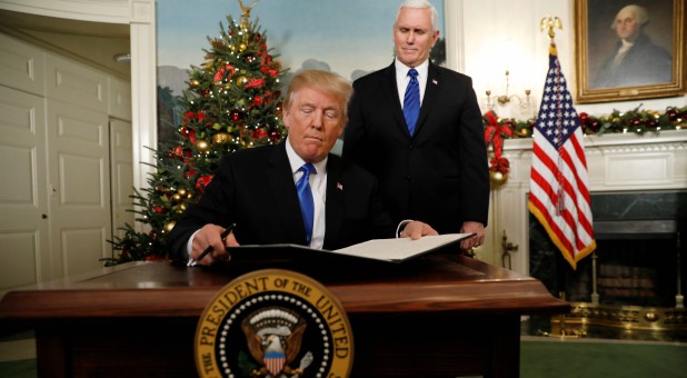 U.S. Vice President Mike Pence stands by as U.S. President Donald Trump signs a proclamation that states the United States recognizes Jerusalem as the capital of Israel and will move its embassy there.