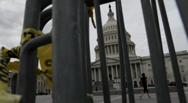 A jogger runs pas the U.S. Capitol during the third day of a government shutdown in Washington.
