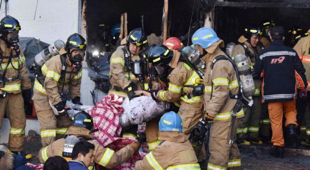 Firefighters rescue a patient from a burnt hospital in Miryang, South Korea.