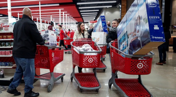 Customers push their shopping carts after making their purchases at Target in Chicago.