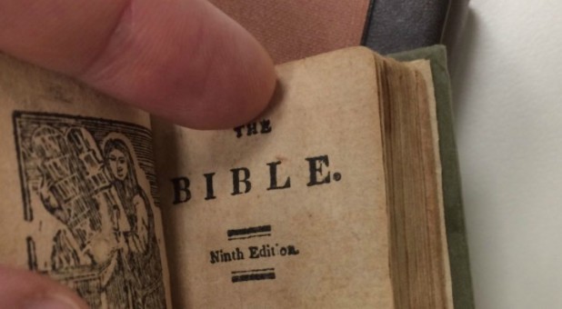 The minuscule book contains several early American woodcuts depicting various biblical scenes and figures.