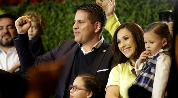Fabricio Alvarado, presidential candidate of the National Restoration party (PRN), greets supporters next to his wife and daughter before delivering a speech during a rally after Costa Rica's presidential election in San Jose, Costa Rica, Feb. 4, 2018.