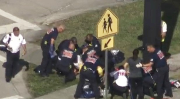 Rescue workers deal with a victim near Marjory Stoneman Douglas High School during a shooting incident in Parkland, Florida.
