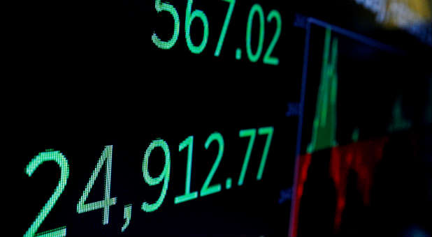 A screen displays the Dow Jones Industrial Average after the closing bell on the floor of the NYSE.