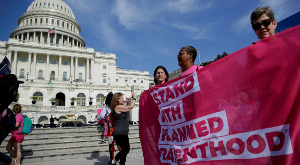 Health care activists with Planned Parenthood and the Center for American Progress protest.