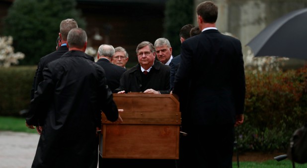The casket containing the late U.S. evangelist Billy Graham is received by his family and others at the Billy Graham Library in Charlotte, North Carolina.