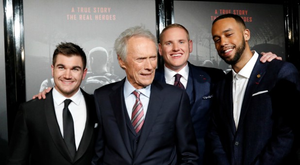 Director Clint Eastwood (3rd R) poses with cast members (L-R) Alek Skarlatos, Spencer Stone and Anthony Sadler at a premiere for